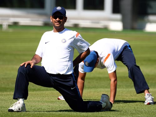MS Dhoni stretches during a training session at Lord's